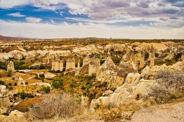 The unique rock caves, fairy chimneys and rock pillars in the Red valley seen from the Panoramic point near Goreme in the Cappadocia Region, Central Anatolia,Turkey.