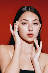 Beauty in Portrait: Young Asian Woman with Clean, Healthy Skin and Natural Makeup, Looking Attractively Glamorous in Studio Background