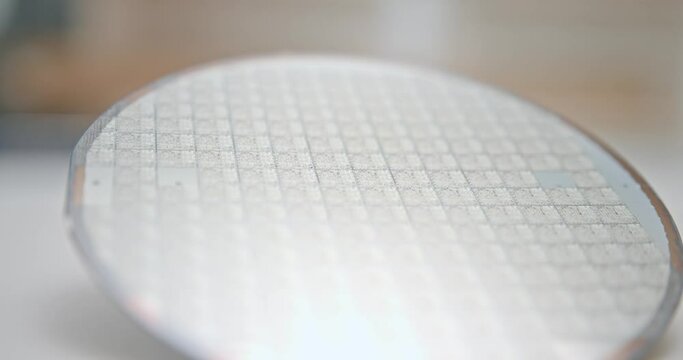 A pattern of microprocessor circuits on a silicon wafer. The semiconductors or central processing unit CPU microchips are fabricated from a silicon wafer with patterned layers of various materials.	