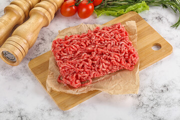 Raw minced beef meat on cutting board