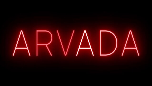 Flickering red retro style neon sign glowing against a black background for ARVADA