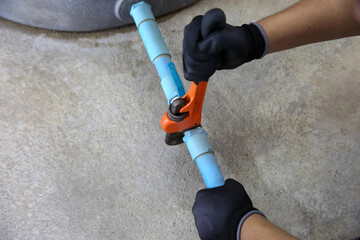 Technician plumber using a wrench to repair a water pump pipe. Concept of maintenance, fix water...