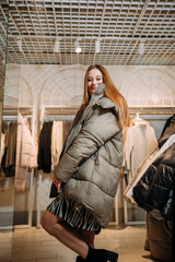 A woman wearing a fur coat and carrying a handba 5851g.