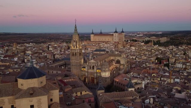 Toledo, Spain: Cinematic aerial drone footage of the cathedral and the 16th century Alcazar palace in Toledo old town in the Castilla-La Mancha in central Spain at sunset