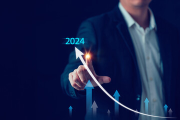 2024 Business goal, Business man pointing chart graph with 2024, future marketing technology concept, Strategy work calendar from now until 2024. Business growth concept.