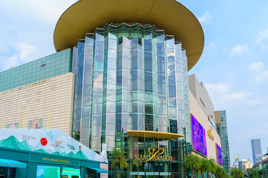 Outside of modern shopping mall Siam Paragon, Luxury shopping mall building and there are many people coming to go shopping.