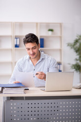 Young male employee working in the office