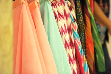 Fabrics with various colors are arranged neatly vertically