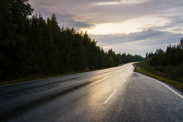 Wet countryside tarmac road in the evening.