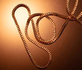 Gold chain in a beautiful gold background