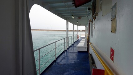 The side deck of a ferry in Italy towards the Mediterranean islands.