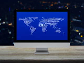 Start up business icon with global words world map on computer screen on table over night city tower, Happy new year 2024 global business start up online, Elements of this image furnished by NASA