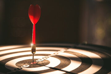 Fototapeta premium Bullseye target goal or dartboard has dart arrow throw hitting center shooting for financial business targeting planning to winner concept.