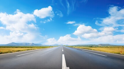 Fototapeta na wymiar asphalt road with white lines, sunny view, blue sky with clouds above,