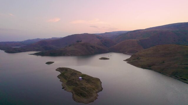 aerial drone rising shot flying over Alsigarh lake Rayta bahubali aravalli hills just outside udaipur a fast growing tourist spot in the city of lakes tourist spot in Rajasthan India shot at dusk