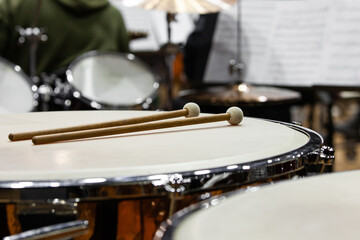 Drumsticks lying on timpani in an orchestra