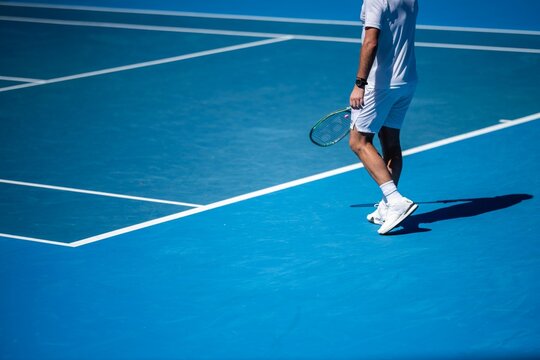 Amateur playing tennis at a tournament and match on blue tennis court in australia