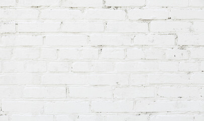 White brick wall background. Old brick wall texture with white cracked paint. Abstract white brick wall wallpaper design. Close up.