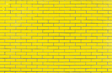 Bright yellow brick wall texture for design. Yellow brick wall background.