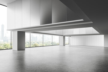 Stylish empty office interior with columns on grey concrete floor, window