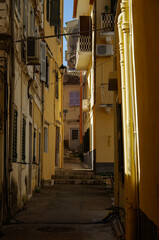 Romantic backstreet, side street or alleys in historic old town of Corfu Island, Greece with...