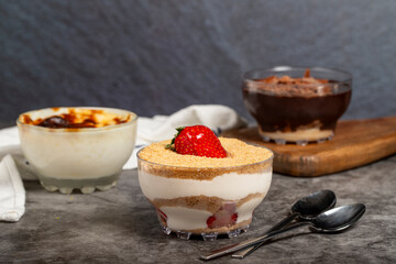 Magnolia, supangle (chocolate pudding) and rice pudding on dark background
