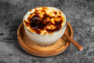 Rice pudding dessert. Rice pudding in bowl on dark background. Close up