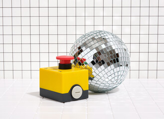 A button to start a fun disco in the club. A shining disco ball and a cheerful mood.