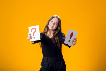 A portrain of kid girl holding cards with question mark and exclamation point. Children, idea and...