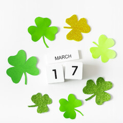 March 17 calendar and green clover leaves top view. St. Patrick's Day concept