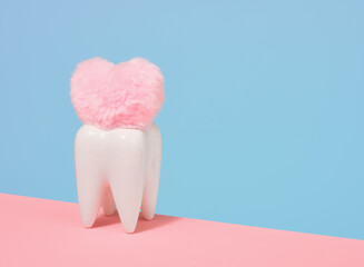 White tooth and soft pink heart. Minimalistic dental composition. Copy space for text.