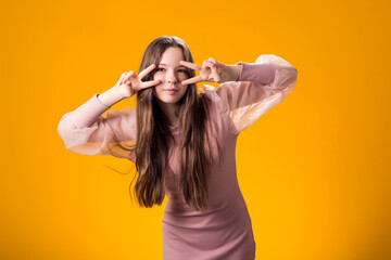 Joyful Young Girl Covering Eyes with Hand, Gazing Through Fingers