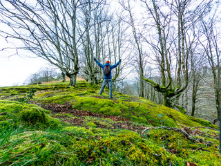 A very happy man in a beech forest in the mountains. Liberty sensation