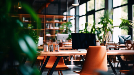 Recreation area in modern office. Green indoor plants create cozy, comfortable and relaxing atmosphere. Large windows let in a lot of natural light. Copy space.