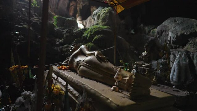 Sacred cave of Tham Phu Kham Vang Vieng, Laos - a stalactite and a stalagmite in the karst mountain with buddha temple inside
