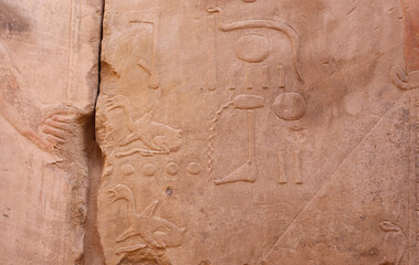 Ancient egyptian carvings and hieroglyphics at Satet temple on Elephantine Island in Aswan, Egypt 