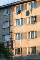 Houses in a poor area where poor people live, a dormitory for workers. Destruction of old houses, earthquakes, economic crisis, people drying clothes outside the window.