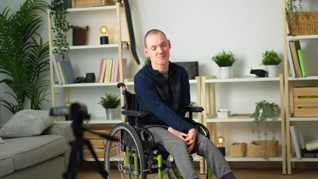 portrait of a happy disabled man in wheelchair at home