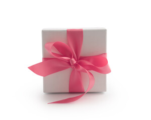 White gift box with pink ribbon bow isolated on white background