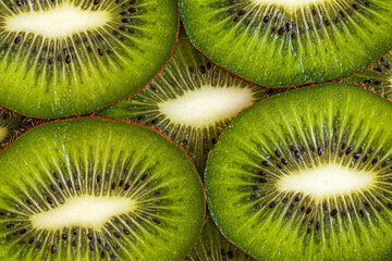 Background of kiwi slices close-up. View from above. Macrography.