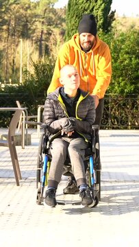 Portrait with copy space of a happy disabled man and friends in a sunny urban park