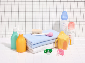 Baby hygiene accessories and clean towels. Cosmetic products and various milk bottles.