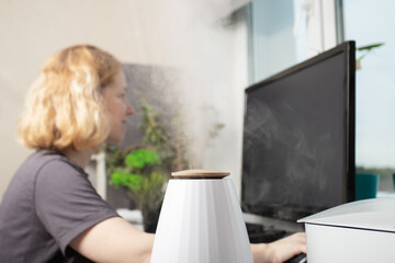 Humidify workplace air, office employee, modern room diffuser, vaporize