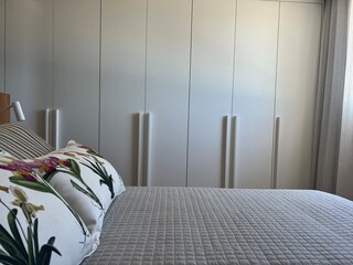 combination of pillows with flower prints and stripes on the bed