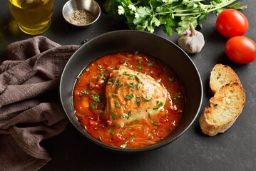 Baked chicken with tomato gravy and herbs