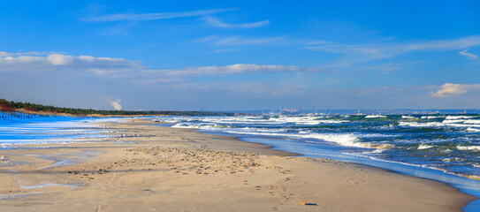 Beautiful scenery of Baltic Sea beach in Sobieszewo at snowy winter, Poland