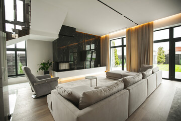 Elegant and comfortable designed cream living room with marble big sofa and big windows