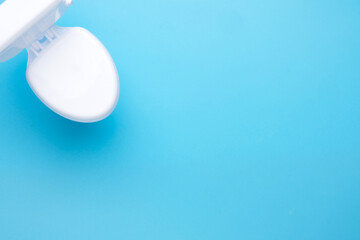 Selective focus toilet bowl on blue background.