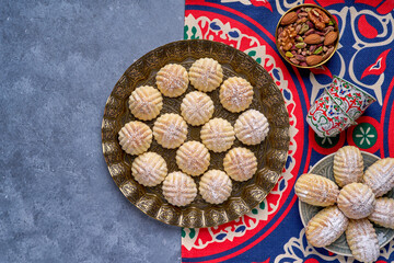 Arabic sweets. Traditional eid semolina maamoul or mamoul cookies with dates , walnuts and pistachio nuts .