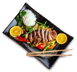 PNG, Asian food. Peking duck, rice and vegetables on a black ceramic plate, isolate 